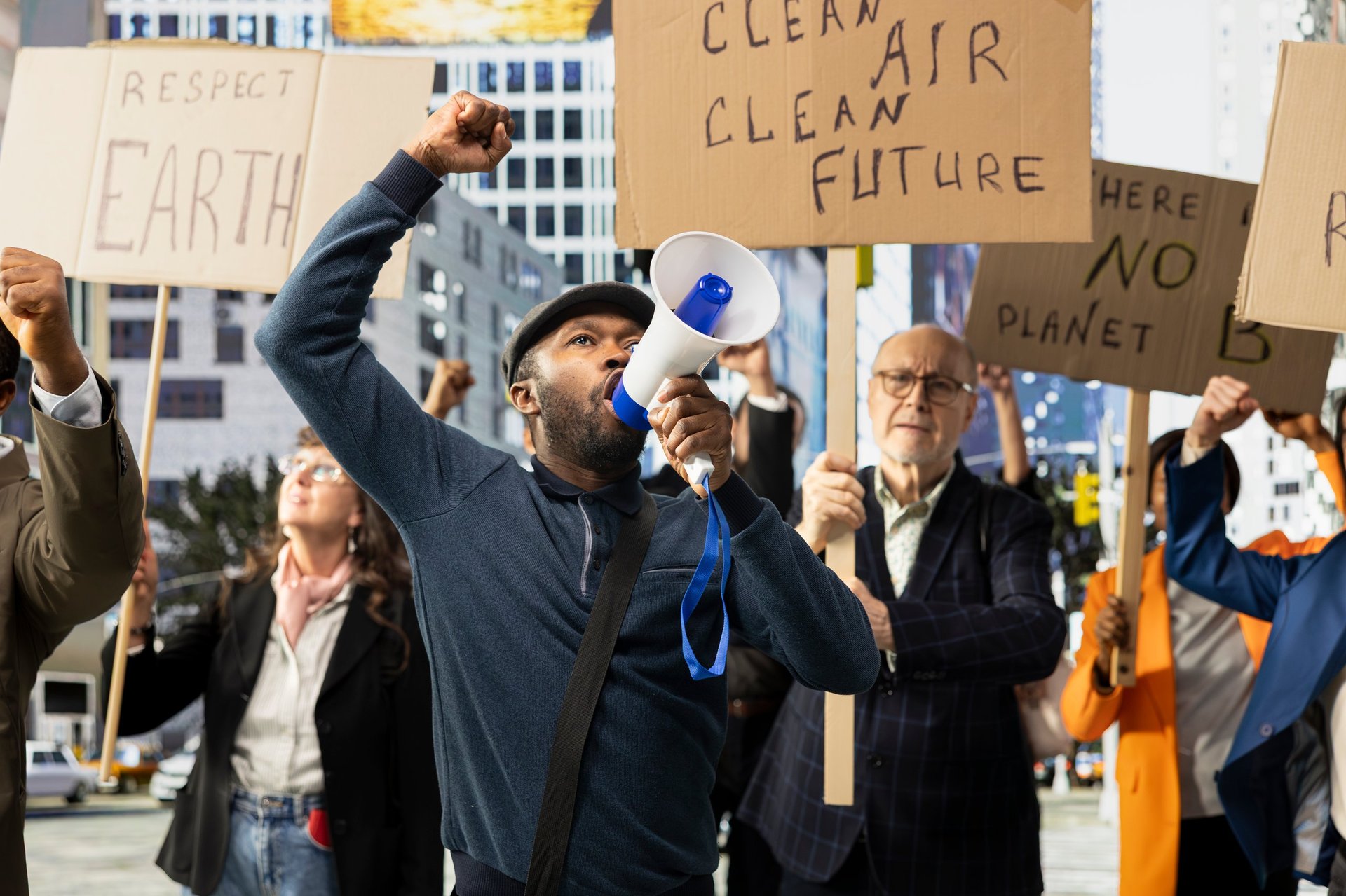 Multiethnic crowd of protesters marching for eco-friendly renewable energy, protecting the nature and planet Earth. Global warming campaign for conservation and sustainability.